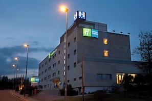 A multi-story Holiday Inn Express building with a prominent 'H' sign on top, multiple windows, and a well-lit entrance. - Holiday Inn Express Barcelona-Montmeló by IHG (Granollers)