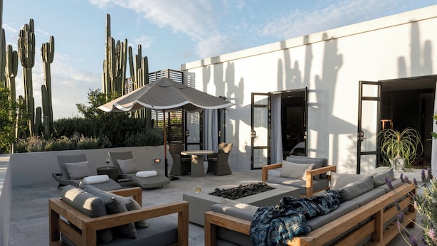 A rooftop patio with outdoor seating, a fire pit, and cacti in the background. - Hotel Matilda, a Member of Design Hotels (San Miguel de Allende)