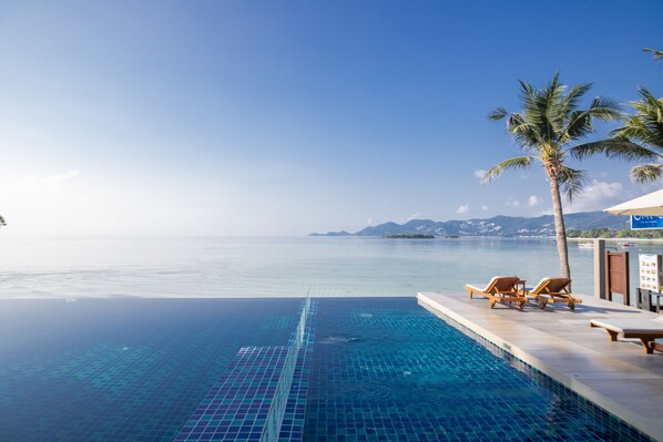 Outdoor pool, open 7 AM to 7 PM, pool umbrellas, pool loungers