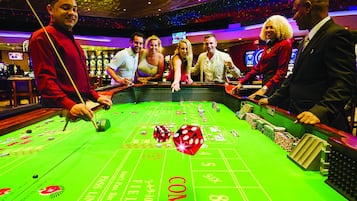 Experience the excitement of the casino floor, where a roulette table awaits with its numbered layout and inviting 'COME' sign.