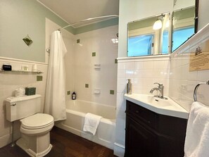 A bathroom with a toilet, a bathtub, a shower, and a sink. - Homestead Inn (New Milford)