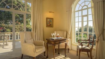 Luxury Suite | Living room | 42-inch flat-screen TV with satellite channels, TV, DVD player