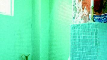 Moroccan Room | Bathroom | Deep-soaking bathtub, rainfall showerhead, designer toiletries