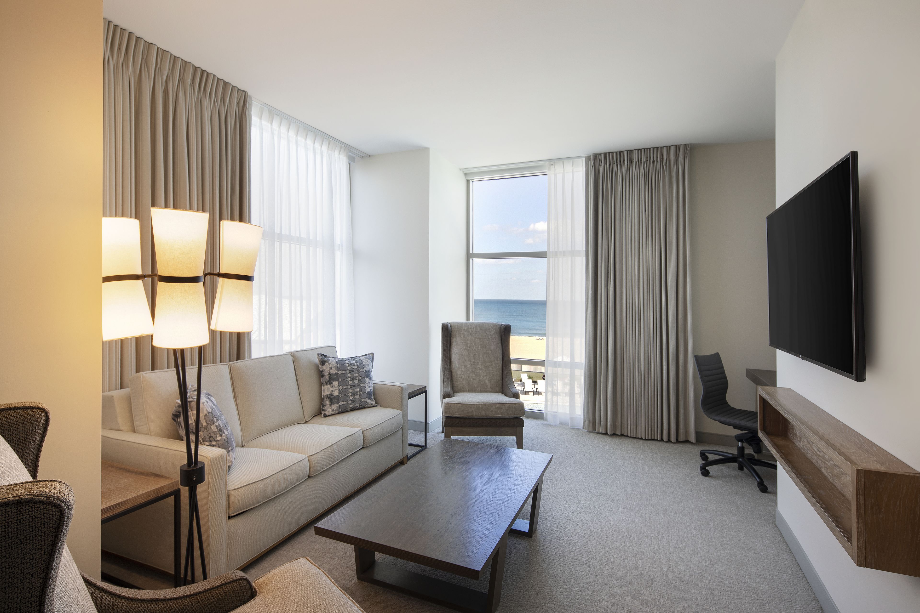 suite, 1 king bed, ocean view, corner | living area | flat-screen tv, pay films, mp3 dock
