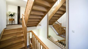 A wooden staircase with a glass railing, leading to a second floor. - Goldener Hecht (Heidelberg)