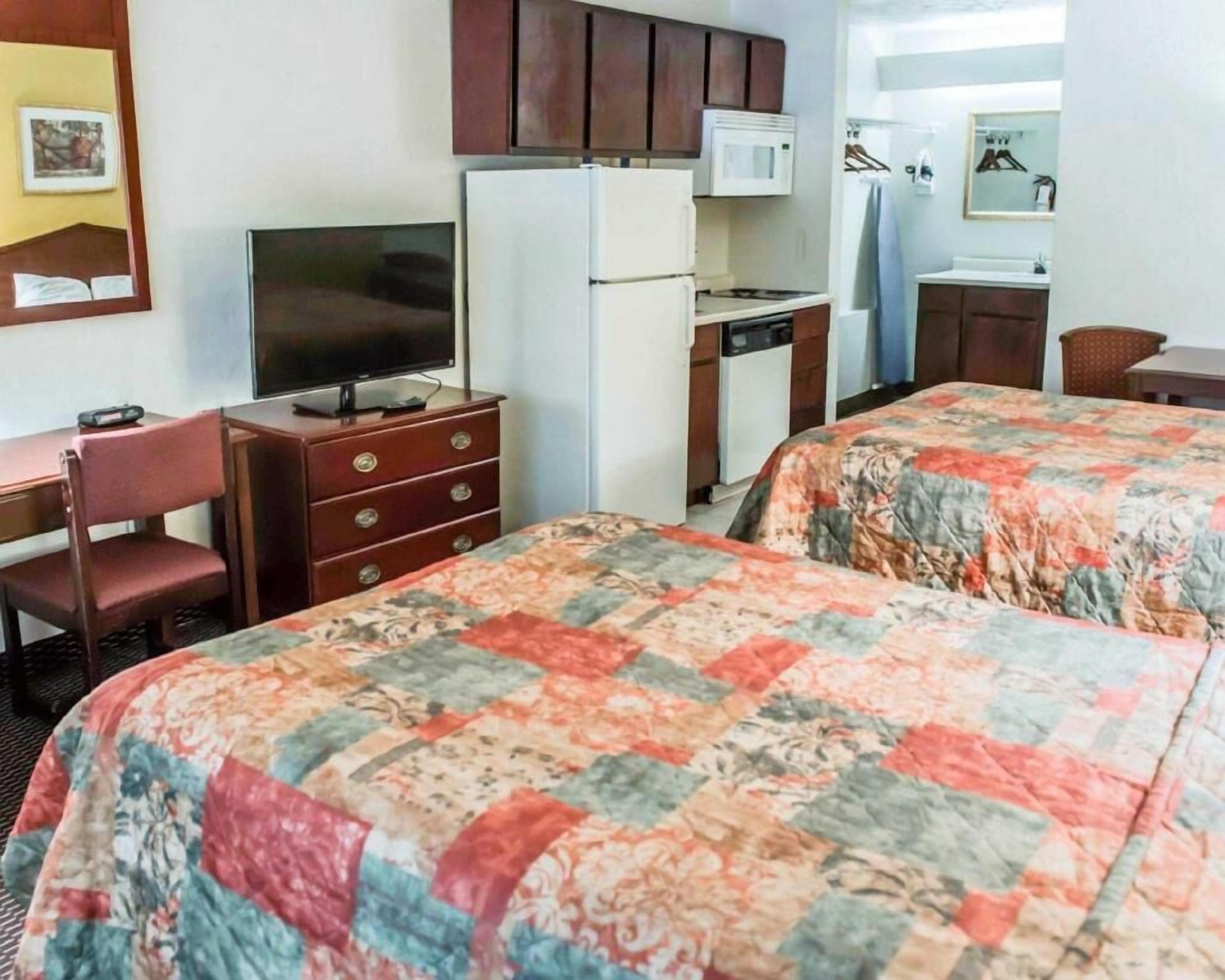 Desk, laptop workspace, iron/ironing board, free cribs/infant beds
