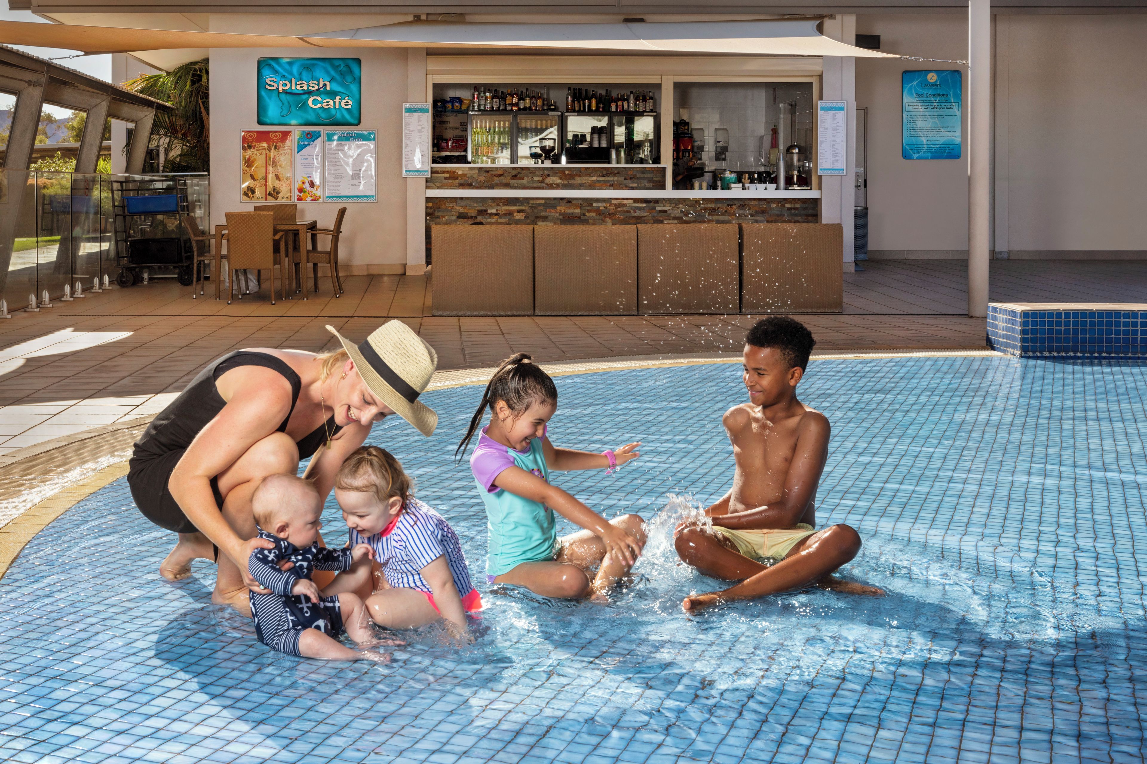 A pool area with a bar and seating.