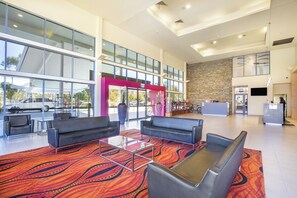 Relax in our spacious lobby, featuring a reception desk, comfortable seating area, and stunning views.
