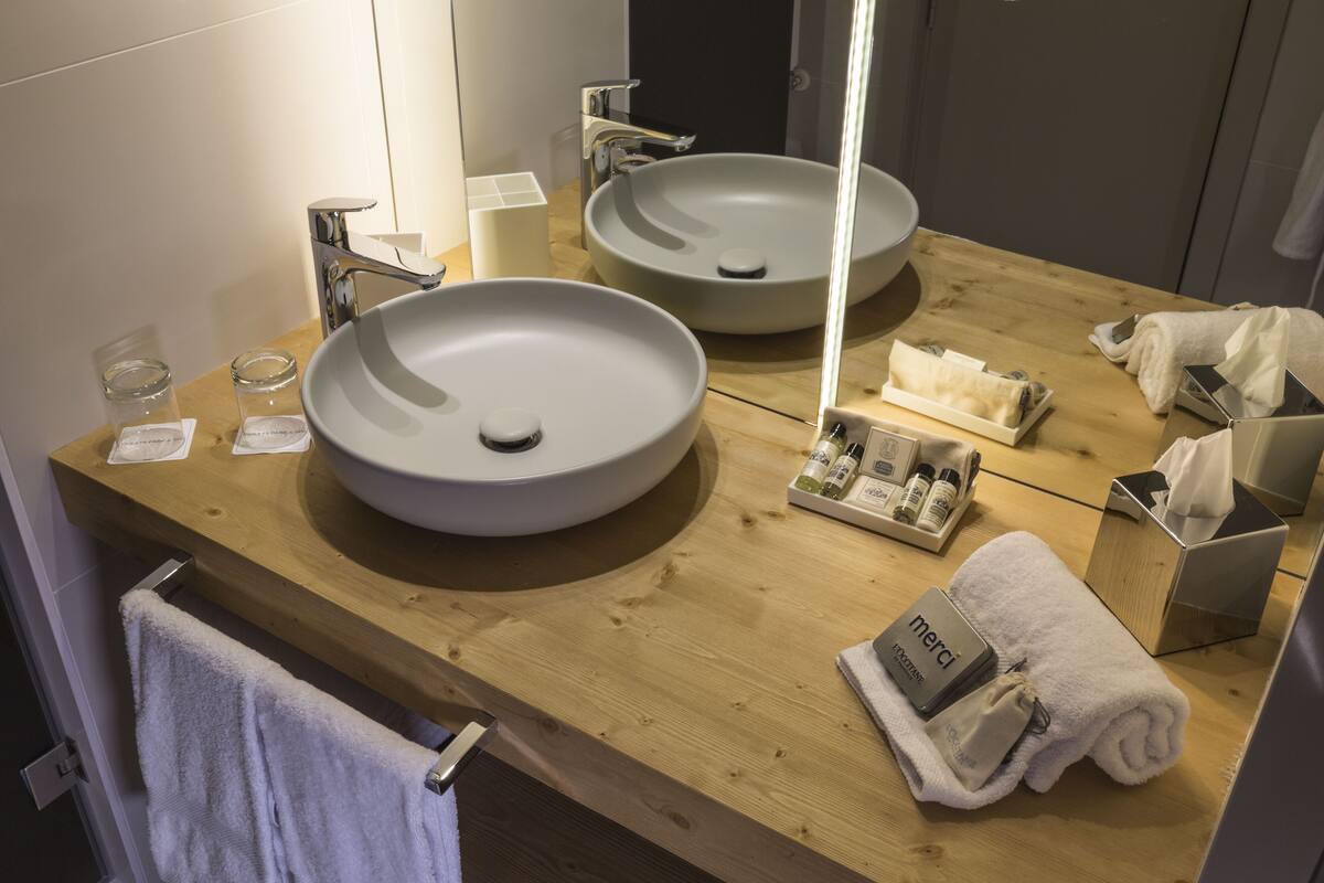 deluxe quadruple room | bathroom | hair dryer, bathrobes, towels