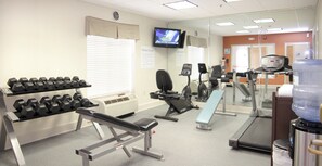 A fitness center with dumbbells, a bench press, an elliptical, and a treadmill. - Holiday Inn Express & Suites Vicksburg by IHG (Vicksburg)