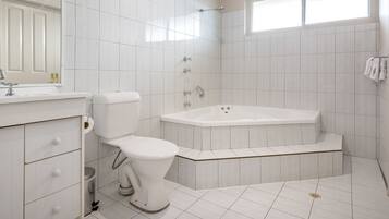 A modern bathroom with a toilet, sink, and bathtub.