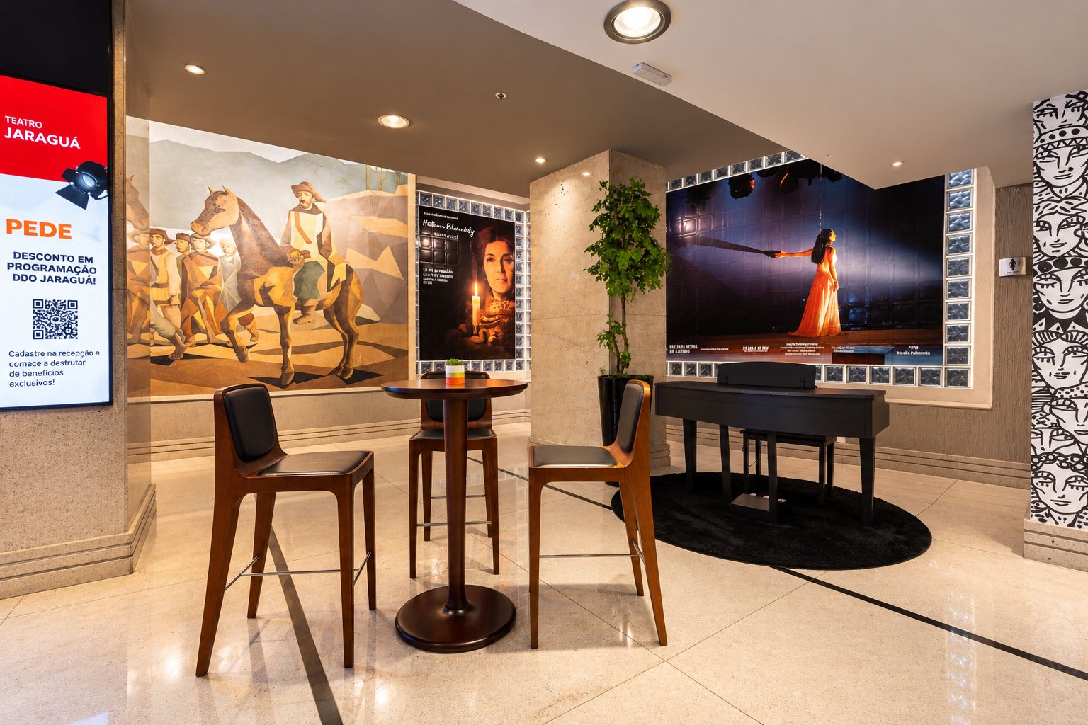 A lobby with a seating area, a large poster, and a television screen.