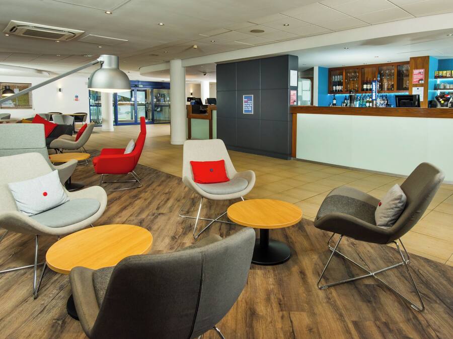 A modern lounge area with seating and a bar.