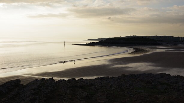 A coastal landscape with a calm sea, rocky shoreline, and a distant hill. - Holiday Inn Express Newport by IHG (Newport)