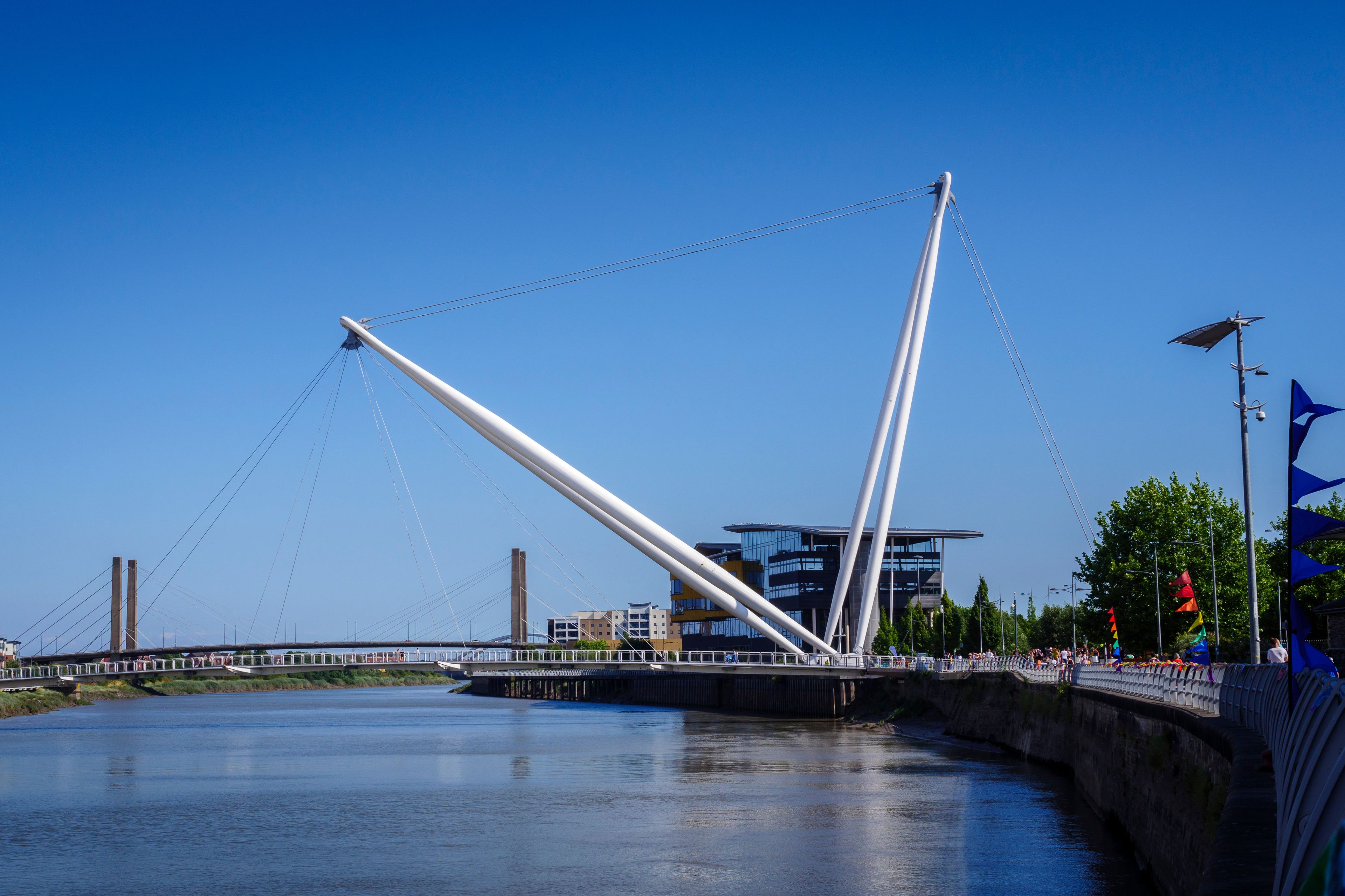 A modern bridge with white cables and a pedestrian walkway.