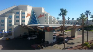 A hotel with a distinctive triangular glass facade and the name 'Avi' prominently displayed. - Avi Resort & Casino (Laughlin)
