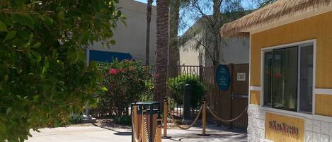 A pool area with a sign indicating pool towels should be removed from the pool area.