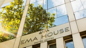 Un edificio con un cartel que dice "EMA HOUSE HOTEL SUITES".