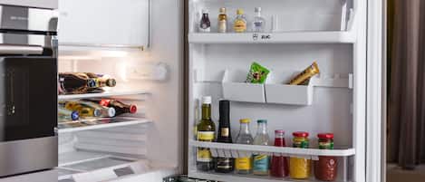 An open refrigerator with various food items and condiments.