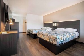 A modern hotel room with two beds, a desk, and a desk lamp. - Motel 6 Bend, OR (Bend)