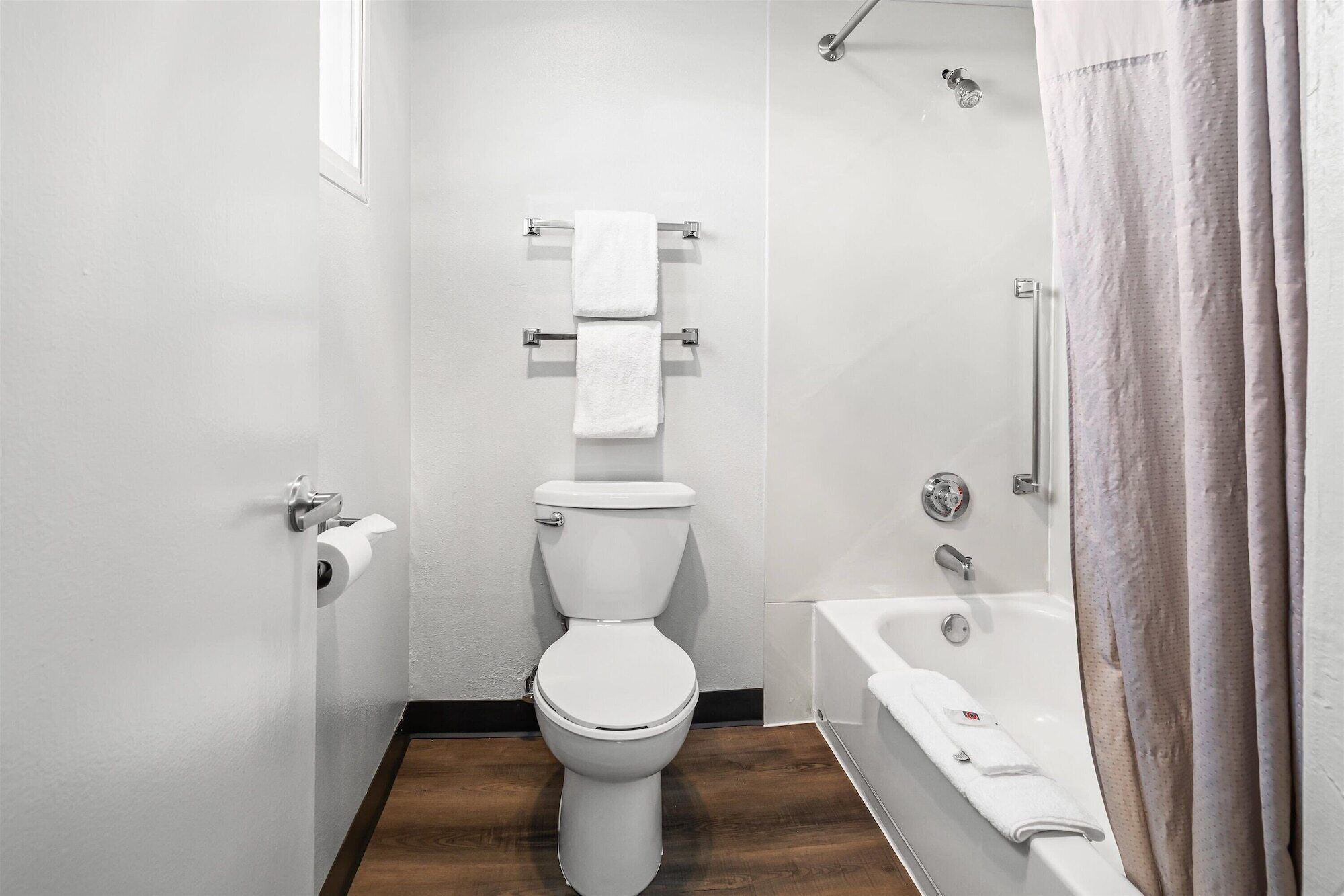 A bathroom with a toilet, a shower, and a bathtub.