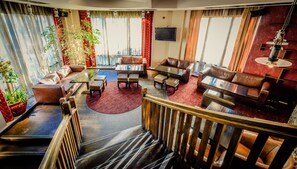 Relax in this elegantly furnished living area with a comfortable seating arrangement and large flat-screen TV.