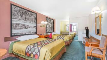 A hotel room with two beds, a desk, a chair, a television, and artwork on the walls.