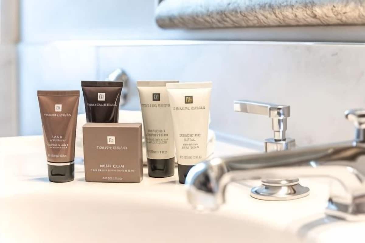 A bathroom sink with various skincare products.