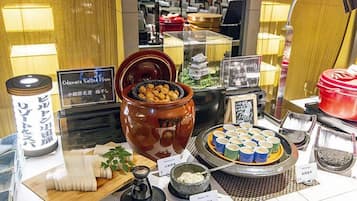 A display of various Japanese sweets and snacks, including a large ceramic jar of mochi and a selection of colorful mochi cups.