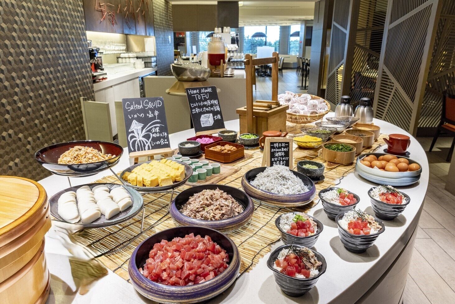 A buffet with various dishes including sushi, rice, and seafood.