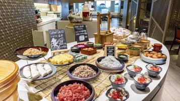 A buffet with various dishes including sushi, rice, and seafood.