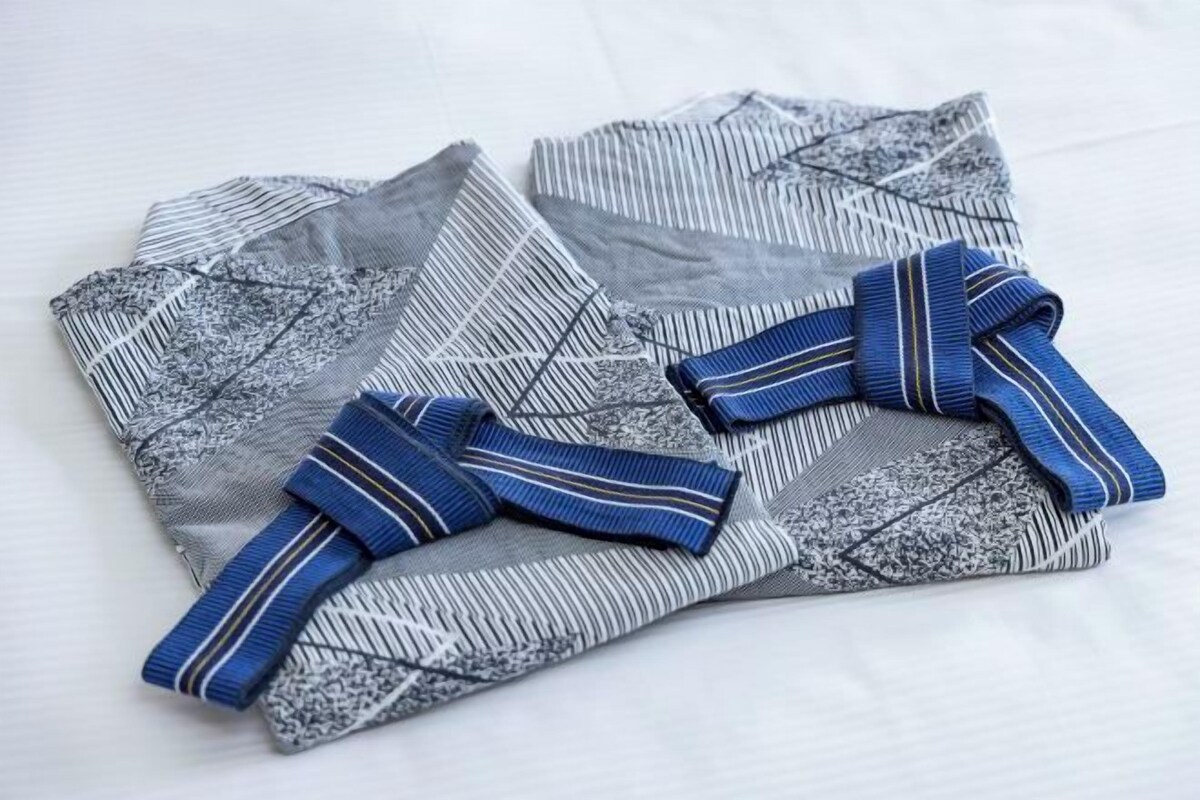A folded garment with a striped pattern and a blue bow.