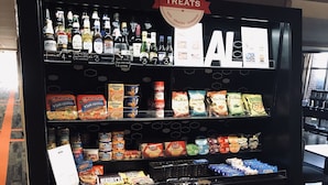 A beverage vending machine with a 'TREAT' sign, offering various drinks and snacks. - Hampton Inn Ft Payne (Fort Payne)