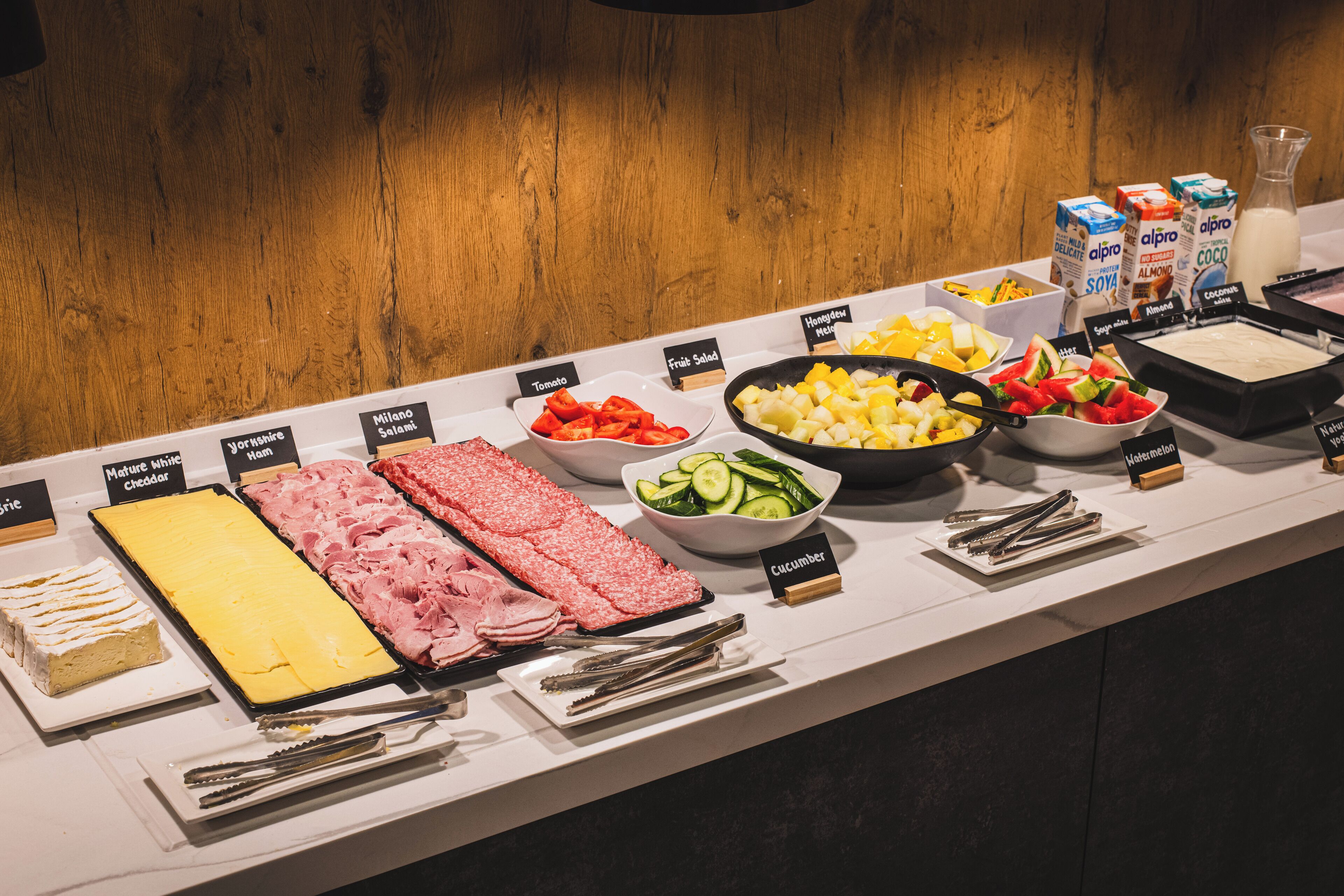 A buffet with various food items and condiments.