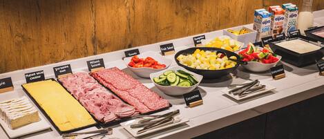 A buffet with various food items and condiments.