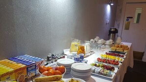 A buffet table with various food items and beverages, including fruits, cereals, and dairy products. - McInnes House rooms with breakfast (Kingussie)
