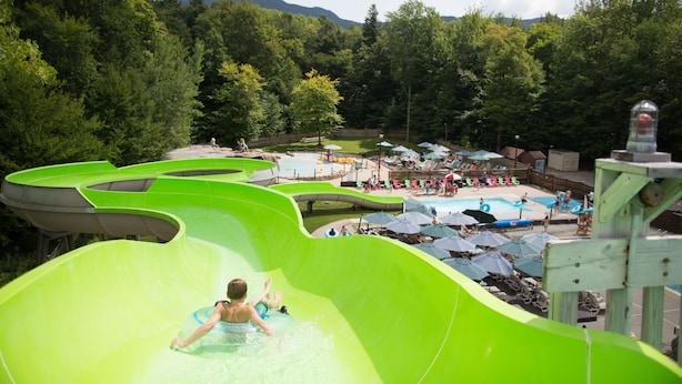 A water park with multiple slides and a swimming pool area. - Smugglers' Notch Resort (Jeffersonville)