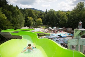 A water park with multiple slides and a swimming pool area. - Smugglers' Notch Resort (Jeffersonville)