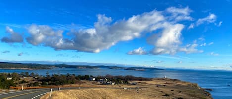 A coastal road with a clear sky and distant mountains.