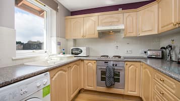 Fridge, microwave, coffee/tea maker, cookware/dishes/utensils