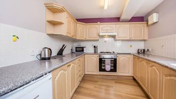 Fridge, microwave, coffee/tea maker, cookware/dishes/utensils