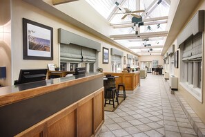 A modern kitchen with a long counter, wooden cabinets, and a skylight. - Club Wyndham Inn on Long Wharf (Newport)