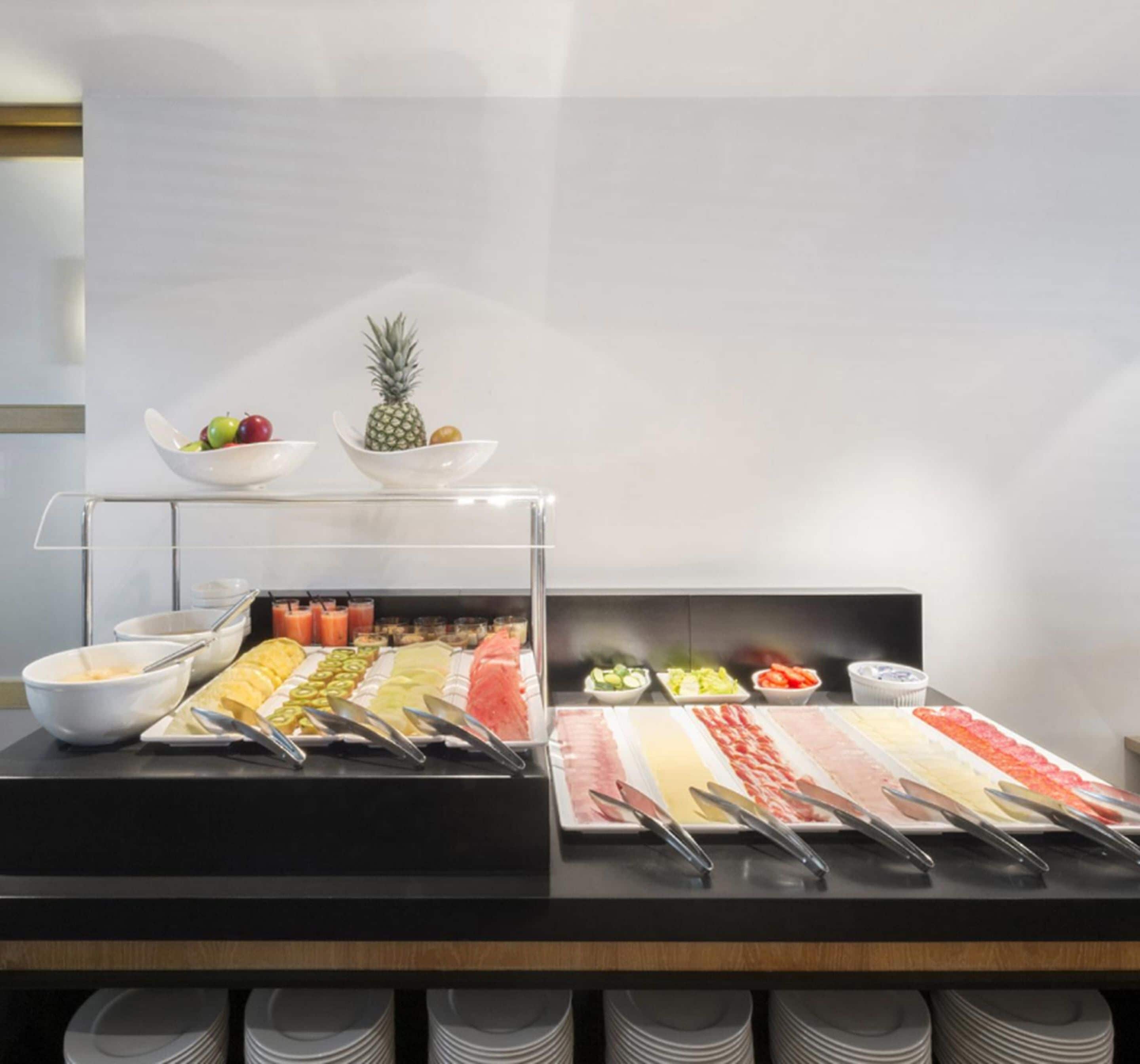 A buffet with various food items and a pineapple on display.