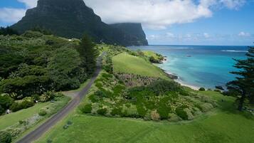 Beach nearby, white sand, beach umbrellas, beach towels