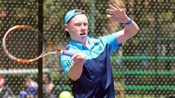 A tennis player in action on a court.