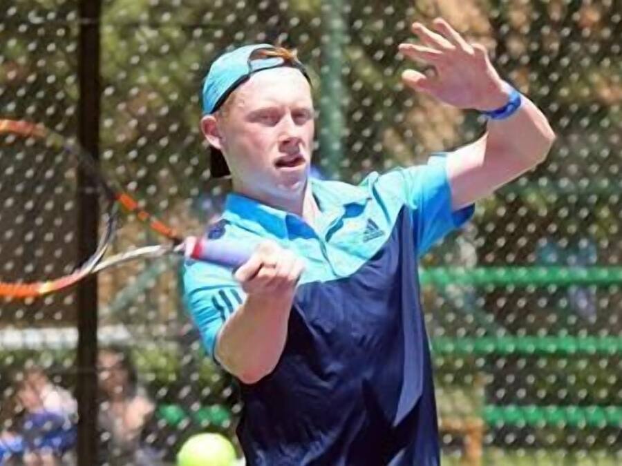 A tennis player in action on a court.