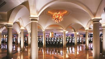 Experience the grandeur of our atrium, featuring a stunning chandelier and elegant columns.