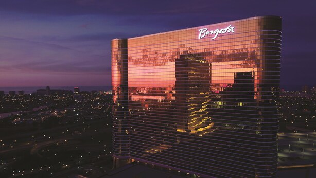 A high-rise building with a reflective glass facade and the name "Borgata" illuminated on the side.