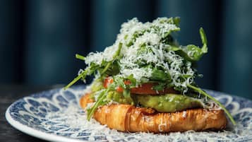 A breakfast sandwich on a decorative plate.