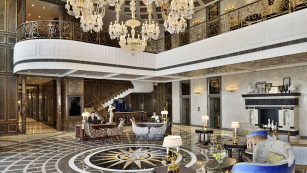 A grand lobby with a large chandelier, a central fountain, and a high ceiling. - Radisson Blu Hotel Noida (Noida)